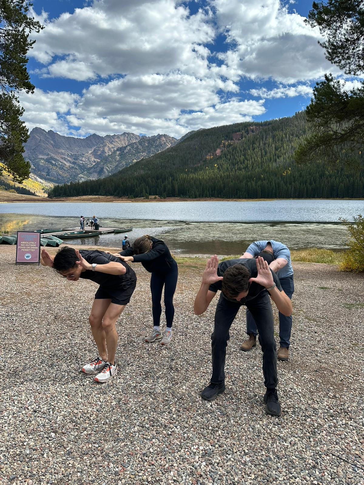 A group of people standing on top of a gravel field.