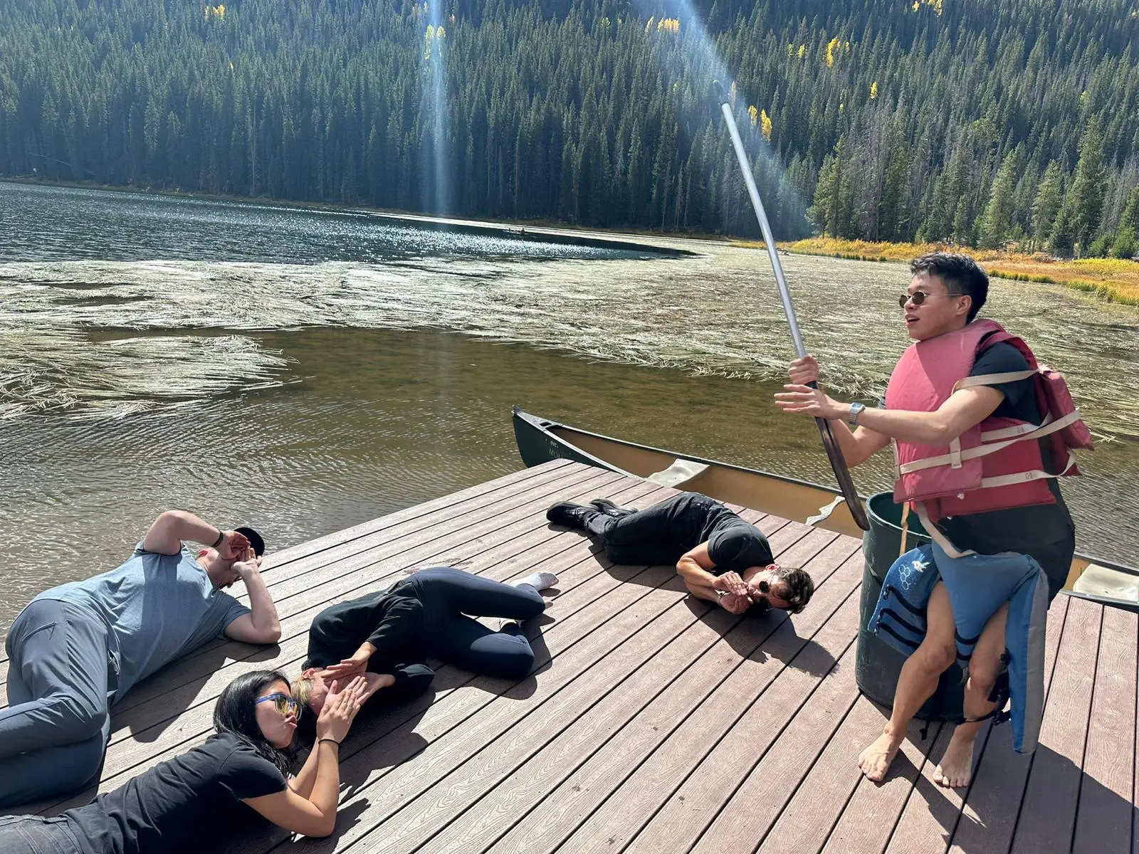 A group of people laying on the dock