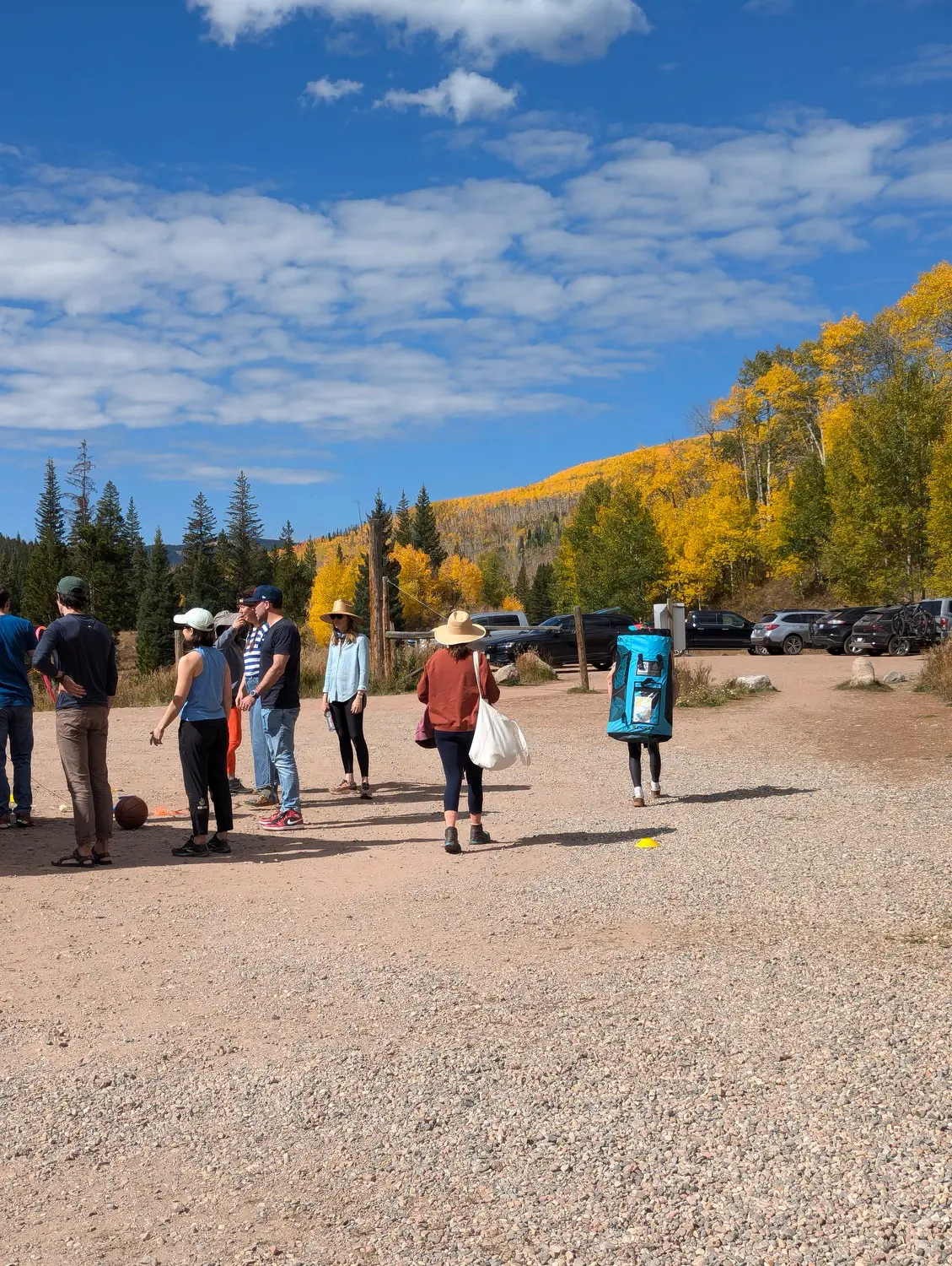 A group of people standing on top of a gravel road.