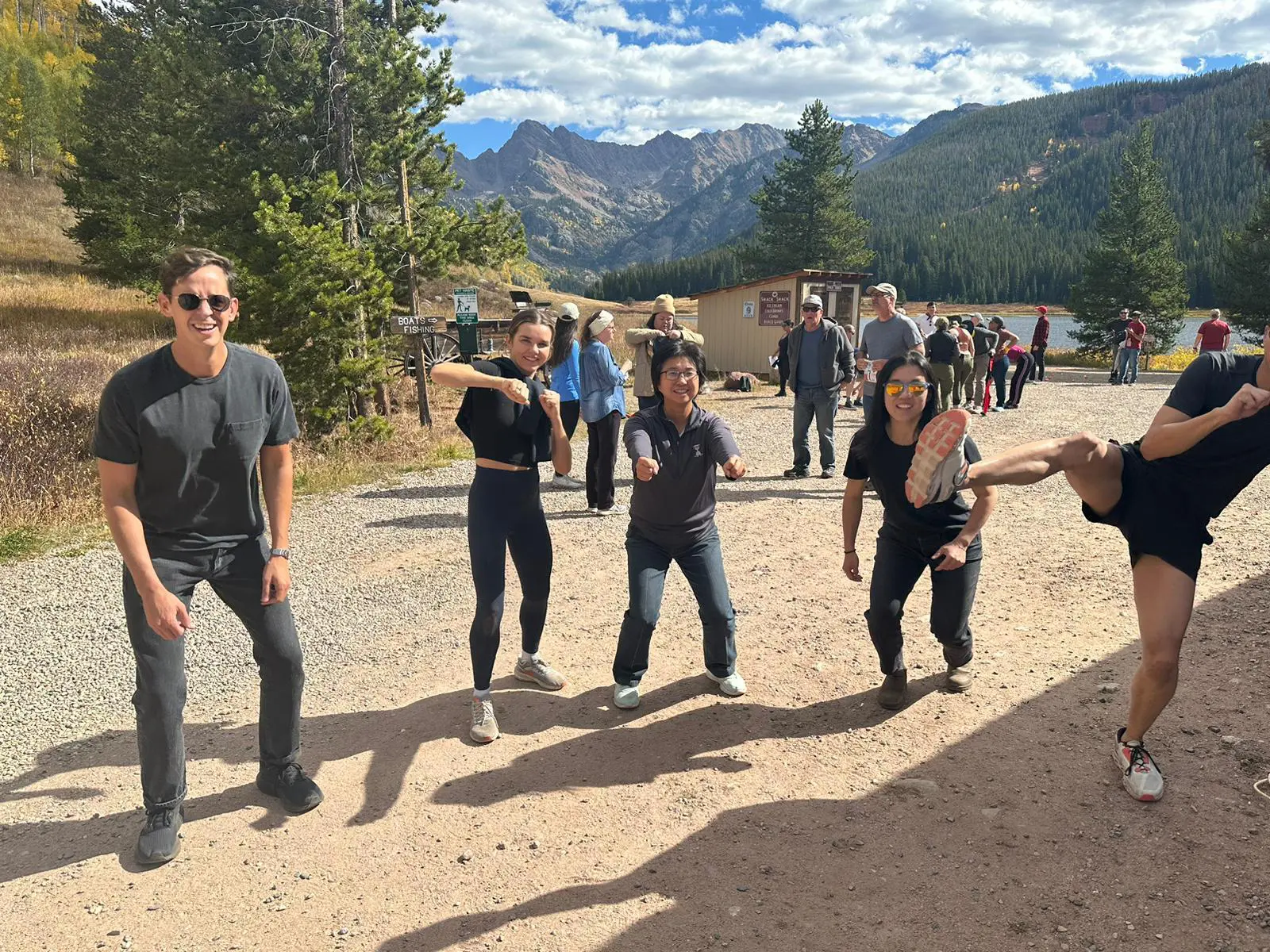 A group of people standing on top of a dirt field.